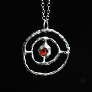 Astrological talisman of fixed star Aldebaran featuring inverted garnet point set in solid sterling silver by Sword + Scythe