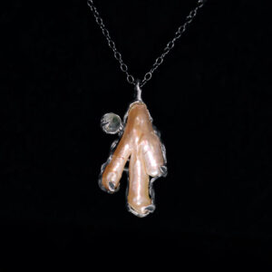 Devotional charm of Baba Yaga featuring chicken foot pearl, moss agate, and saltwater pearl in solid sterling silver.