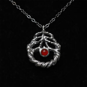 A devotional charm honoring Inanna’s descent, inspired by her shugurra. Features carnelian, rose, and bull horn in solid sterling silver by Sword + Scythe