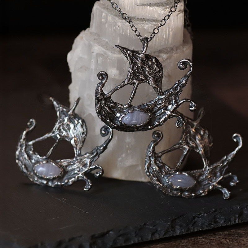 Astrological talismans of Argo Navis featuring blue lace agate above seaweed and 24k gold flake in sterling silver by Sword + Scythe