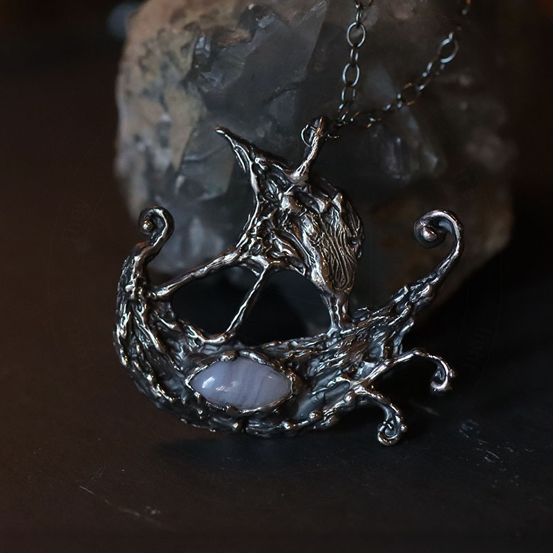 Astrological talismans of Argo Navis featuring blue lace agate above seaweed and 24k gold flake in sterling silver by Sword + Scythe