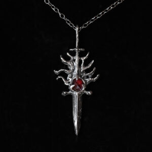 Protective amulets of Saint George featuring garnet set with St George powder in solid sterling silver by Sword + Scythe. Part of a joint release with With Cunning and Command.