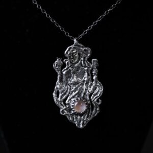 Astrological talismans of Venus in Libra featuring mother of pearl quartz doublet set with rose, vervain, and lovage in solid sterling silver by Sword + Scythe.